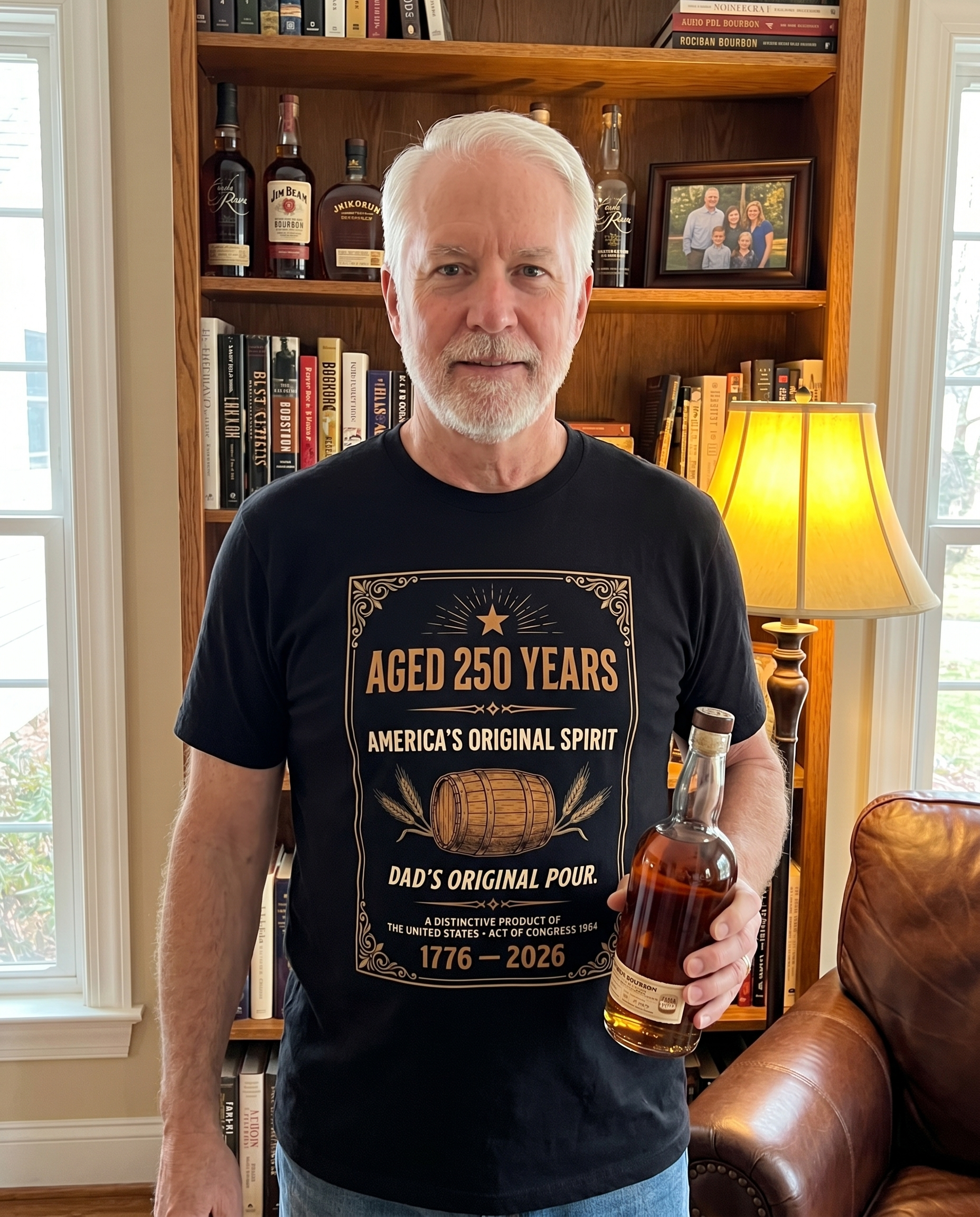 Dad wearing Aged 250 Years t-shirt in home study with bourbon bottle